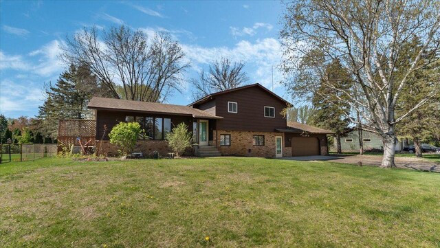 split level home featuring brick siding, driveway, and an attached garage