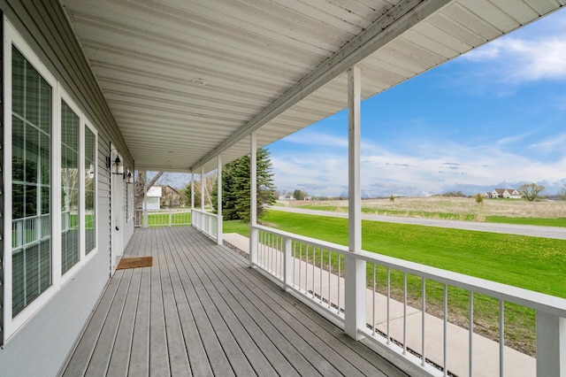 wooden deck with a lawn and a porch