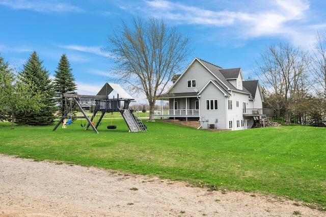 back of house with a lawn and a playground