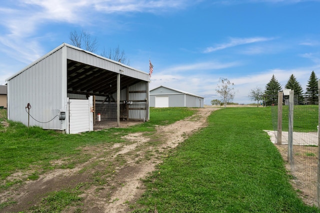 view of pole building with a yard and driveway
