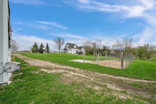 exterior space featuring a lawn and volleyball court