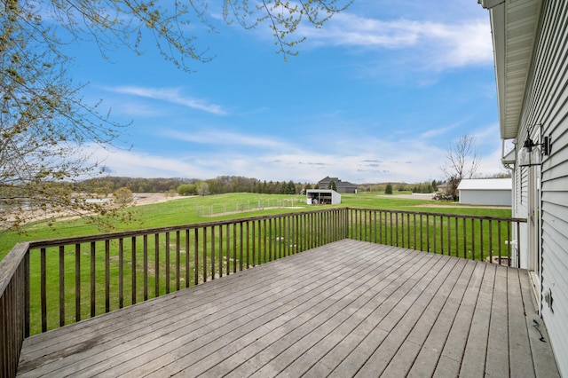 wooden terrace with a lawn and a rural view