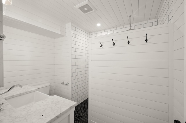 bathroom featuring walk in shower, a sink, toilet, recessed lighting, and visible vents