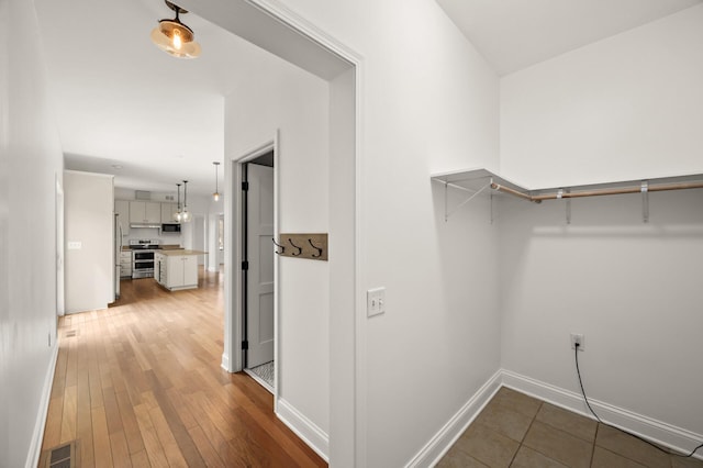 walk in closet with wood-type flooring and visible vents