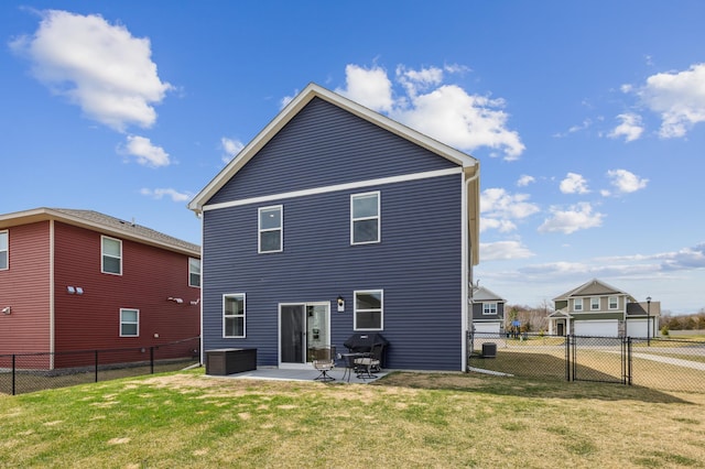 rear view of house featuring a lawn, a patio, and a fenced backyard