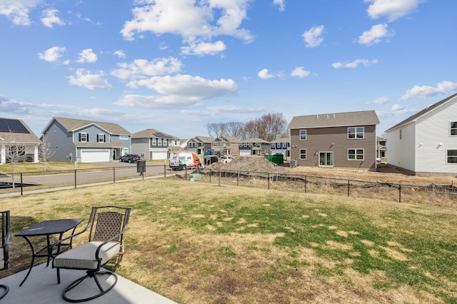 view of yard featuring fence and a residential view