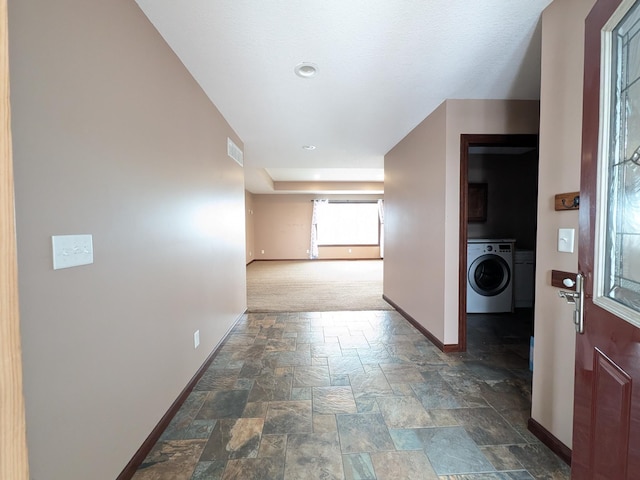 580 Canyon Ln NW, Eyota, MN 55934 - corridor with baseboards, washer / dryer, and dark stone finish floors