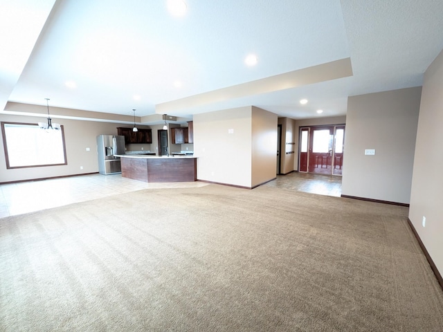 580 Canyon Ln NW, Eyota, MN 55934 - unfurnished living room featuring light colored carpet, baseboards, and recessed lighting
