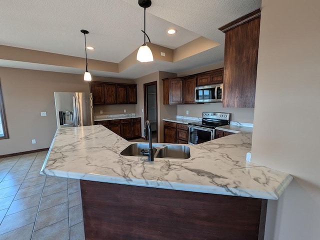 580 Canyon Ln NW, Eyota, MN 55934 - kitchen with appliances with stainless steel finishes, a sink, a tray ceiling, baseboards, and dark brown cabinetry