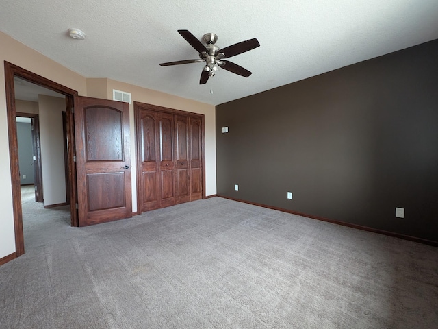 580 Canyon Ln NW, Eyota, MN 55934 - unfurnished bedroom featuring carpet flooring, ceiling fan, baseboards, and a textured ceiling