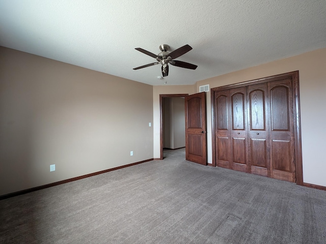 580 Canyon Ln NW, Eyota, MN 55934 - unfurnished bedroom with baseboards, light carpet, a ceiling fan, and a textured ceiling