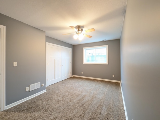 580 Canyon Ln NW, Eyota, MN 55934 - unfurnished bedroom featuring carpet, baseboards, ceiling fan, and a closet