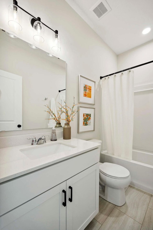 bathroom featuring visible vents, vanity, wood finished floors, toilet, and shower / tub combo