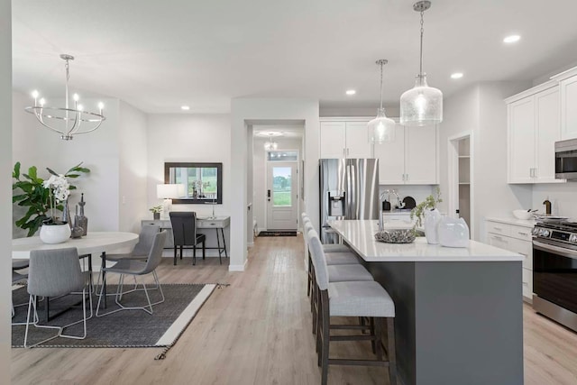 12439 Drayton Trl, Apple Valley, MN 55124 - kitchen featuring stainless steel appliances, light wood-style floors, white cabinets, light countertops, and recessed lighting