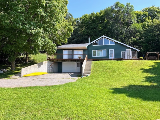 view of front facade with stairway, driveway, a front yard, and a garage