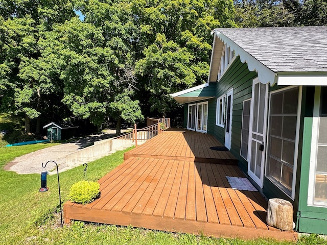 wooden deck featuring a lawn