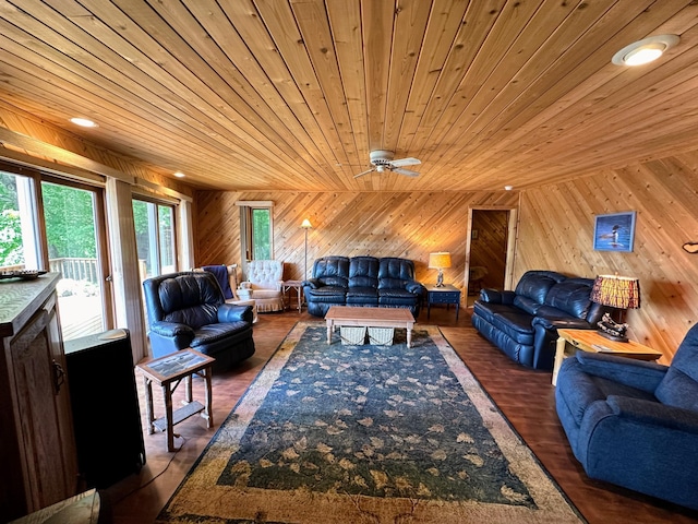 living room with wooden walls, a healthy amount of sunlight, and wood ceiling