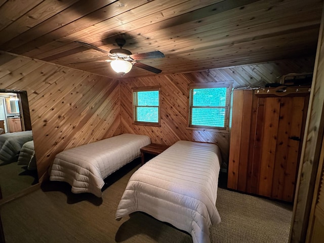 carpeted bedroom with ceiling fan, wood walls, and wood ceiling
