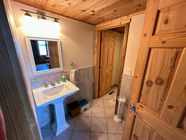 bathroom featuring wooden ceiling, tile walls, wainscoting, and tile patterned flooring