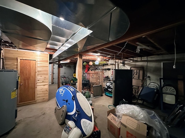 unfinished basement featuring electric water heater