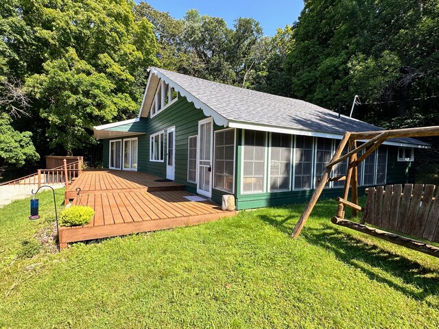 36018 504th St, Hobart Twp, MN 56544 - back of house with roof with shingles, a sunroom, and a deck