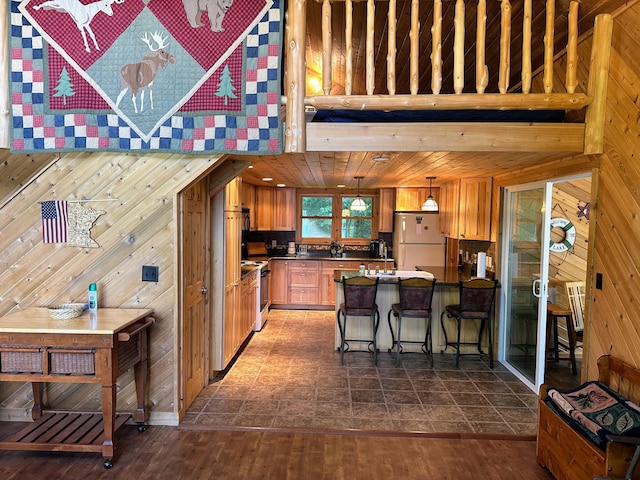 36018 504th St, Hobart Twp, MN 56544 - kitchen with freestanding refrigerator, wood walls, a peninsula, range with electric cooktop, and a breakfast bar area