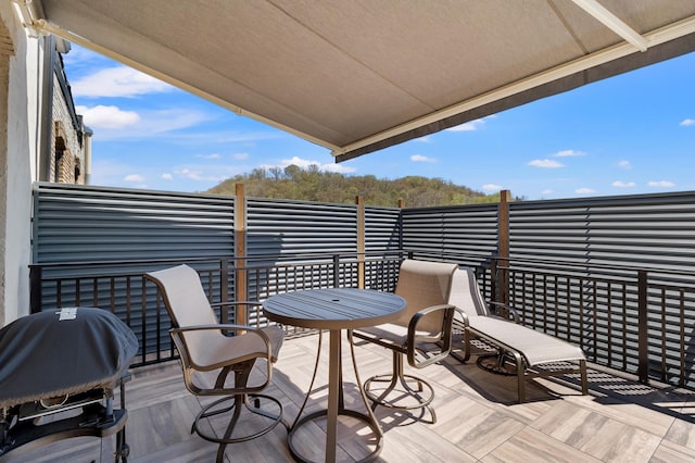 wooden terrace with a grill