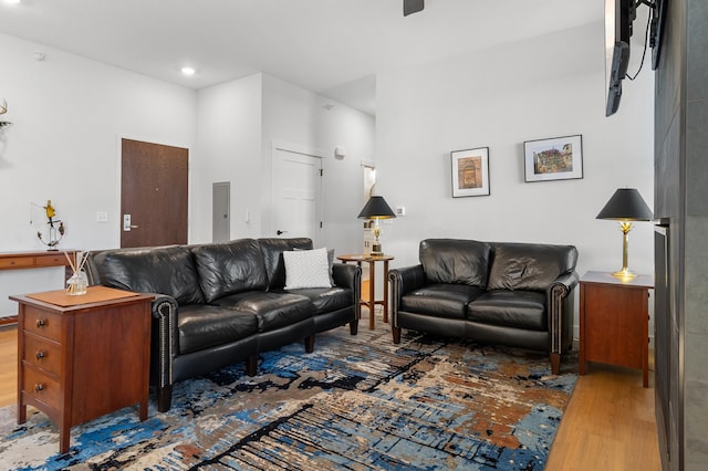 living room with wood finished floors and recessed lighting