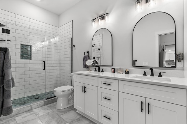 full bath featuring marble look tiles, a stall shower, toilet, and double vanity