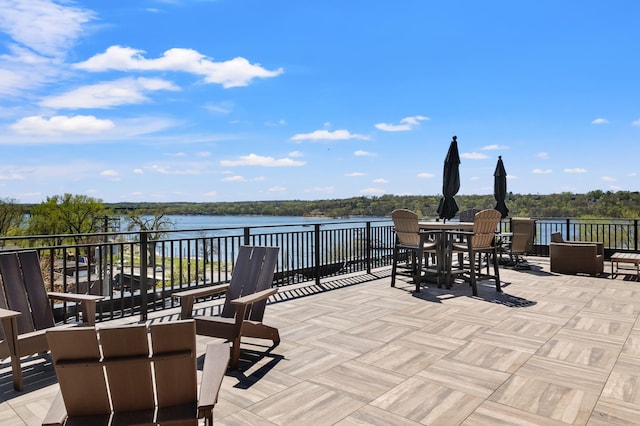 view of patio featuring a water view and outdoor dining area