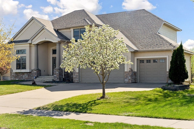 10123 Yates Ave N, Brooklyn Park, MN 55443 - view of front of house featuring stone siding, concrete driveway, and stucco siding