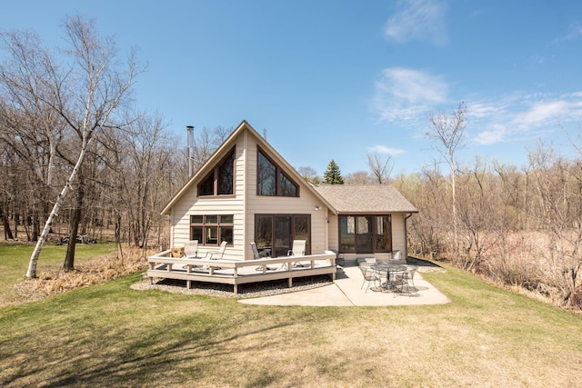 1844 Mount Carmel Dr NE, Alexandria, MN 56308 - back of property with a patio, a shingled roof, a yard, and a deck
