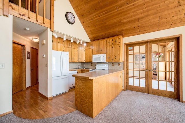1844 Mount Carmel Dr NE, Alexandria, MN 56308 - kitchen featuring lofted ceiling, french doors, white appliances, rail lighting, and a peninsula