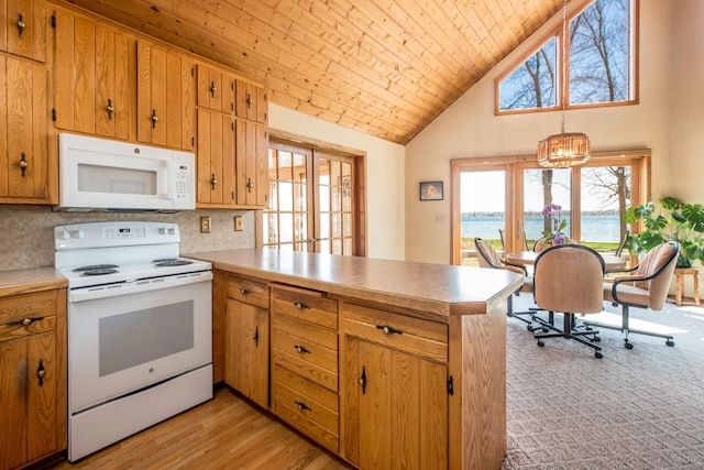 1844 Mount Carmel Dr NE, Alexandria, MN 56308 - kitchen featuring white appliances, light countertops, a peninsula, and high vaulted ceiling