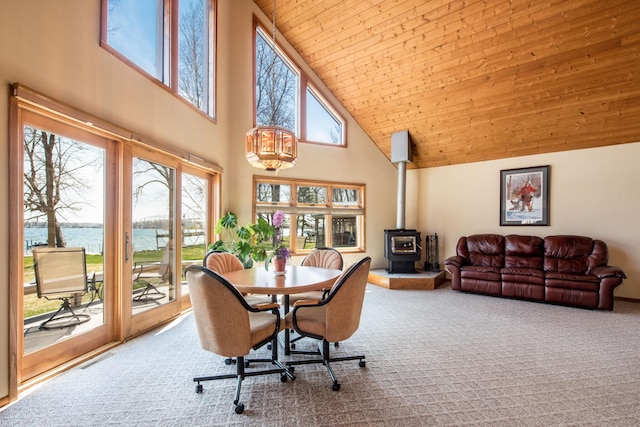 1844 Mount Carmel Dr NE, Alexandria, MN 56308 - dining space featuring a wood stove, a wealth of natural light, a water view, and high vaulted ceiling