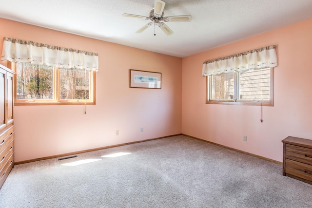 1844 Mount Carmel Dr NE, Alexandria, MN 56308 - unfurnished bedroom featuring carpet, visible vents, baseboards, and ceiling fan