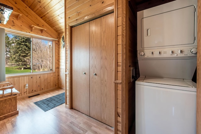 1844 Mount Carmel Dr NE, Alexandria, MN 56308 - washroom with wood walls, laundry area, visible vents, light wood finished floors, and stacked washing maching and dryer