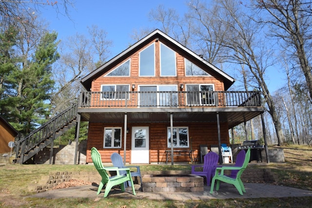 3585 Rigby Rd, Webster, WI 54893 - rear view of property featuring stairs, a fire pit, a patio area, and a deck