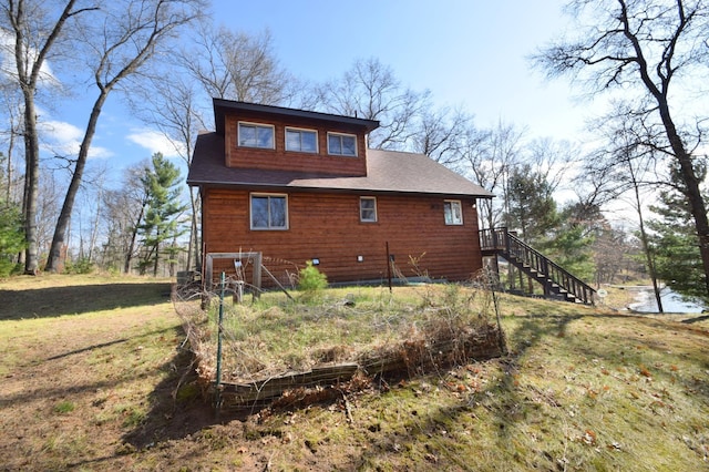 3585 Rigby Rd, Webster, WI 54893 - rear view of house with a lawn and stairway