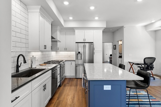517 2nd St Unit 303, Hudson, WI 54016 - kitchen with appliances with stainless steel finishes, a sink, a kitchen breakfast bar, a kitchen island, and recessed lighting