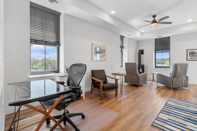 517 2nd St Unit 303, Hudson, WI 54016 - home office featuring a wood stove, recessed lighting, ceiling fan, light wood finished floors, and baseboards
