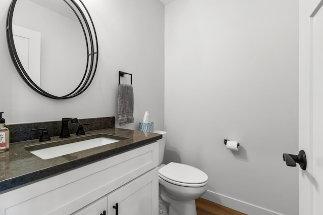 517 2nd St Unit 303, Hudson, WI 54016 - half bathroom with vanity, toilet, and wood finished floors