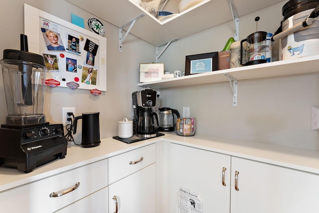 kitchen featuring white cabinets, open shelves, and light countertops
