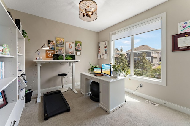 office area with baseboards, visible vents, a chandelier, and light colored carpet