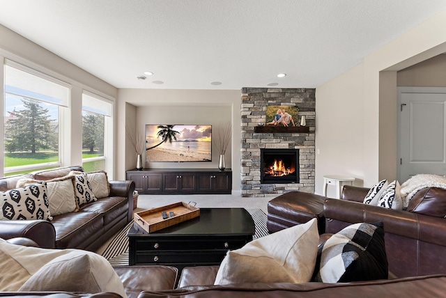 living area featuring a stone fireplace