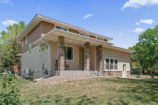 2895 Thunder Bay Ct, Little Canada, MN 55117 - back of house with stone siding, a lawn, covered porch, and cooling unit
