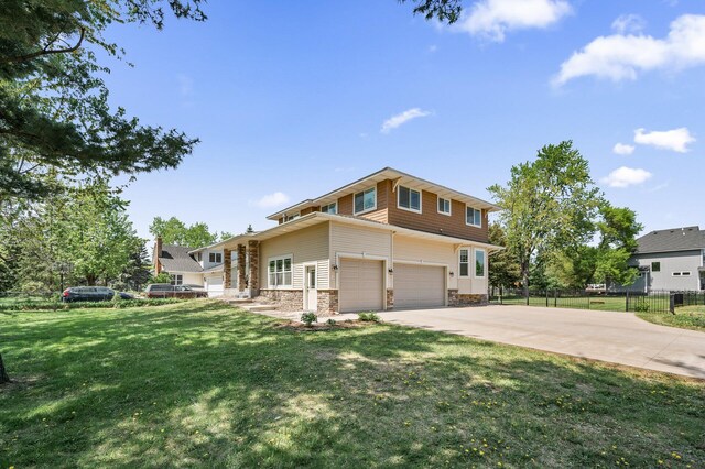 2895 Thunder Bay Ct, Little Canada, MN 55117 - view of front of house featuring stone siding, concrete driveway, and a garage