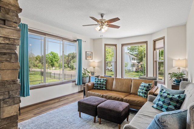 2895 Thunder Bay Ct, Little Canada, MN 55117 - living room with a ceiling fan, a textured ceiling, wood finished floors, and baseboards