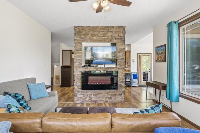 2895 Thunder Bay Ct, Little Canada, MN 55117 - living area with ceiling fan, wood finished floors, a fireplace, and baseboards