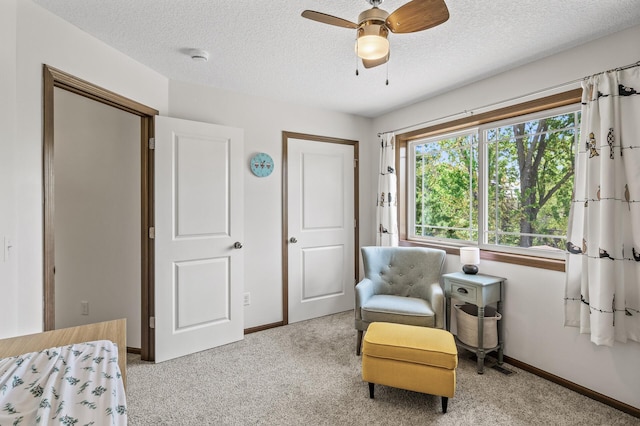 2895 Thunder Bay Ct, Little Canada, MN 55117 - living area featuring carpet floors, baseboards, a textured ceiling, and ceiling fan